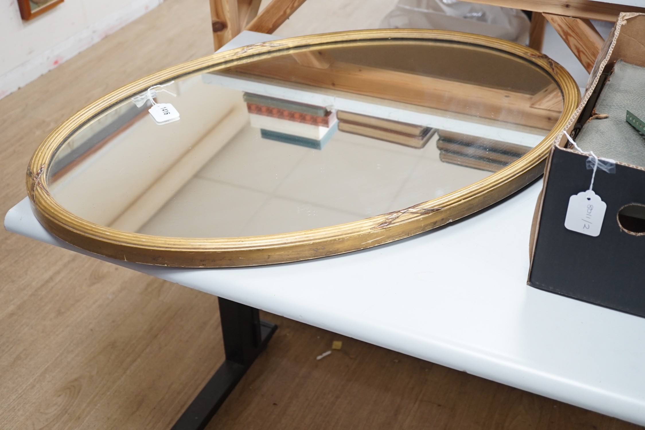 A Victorian oval giltwood framed mirror, 86x58cm